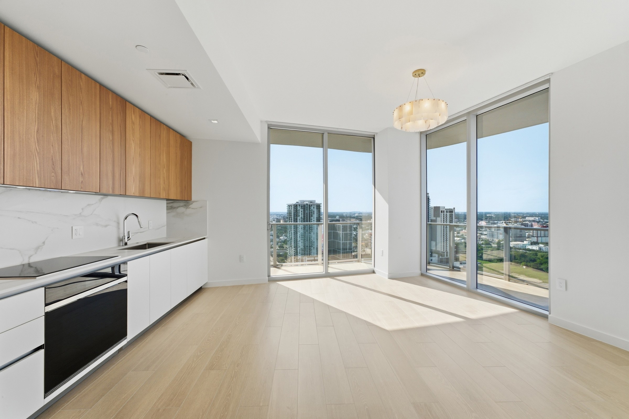 Open living area and kitchen framed by skyline views