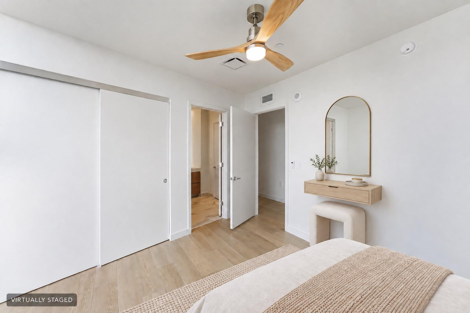 Virtually staged bedroom interior with closet and adjoining bath