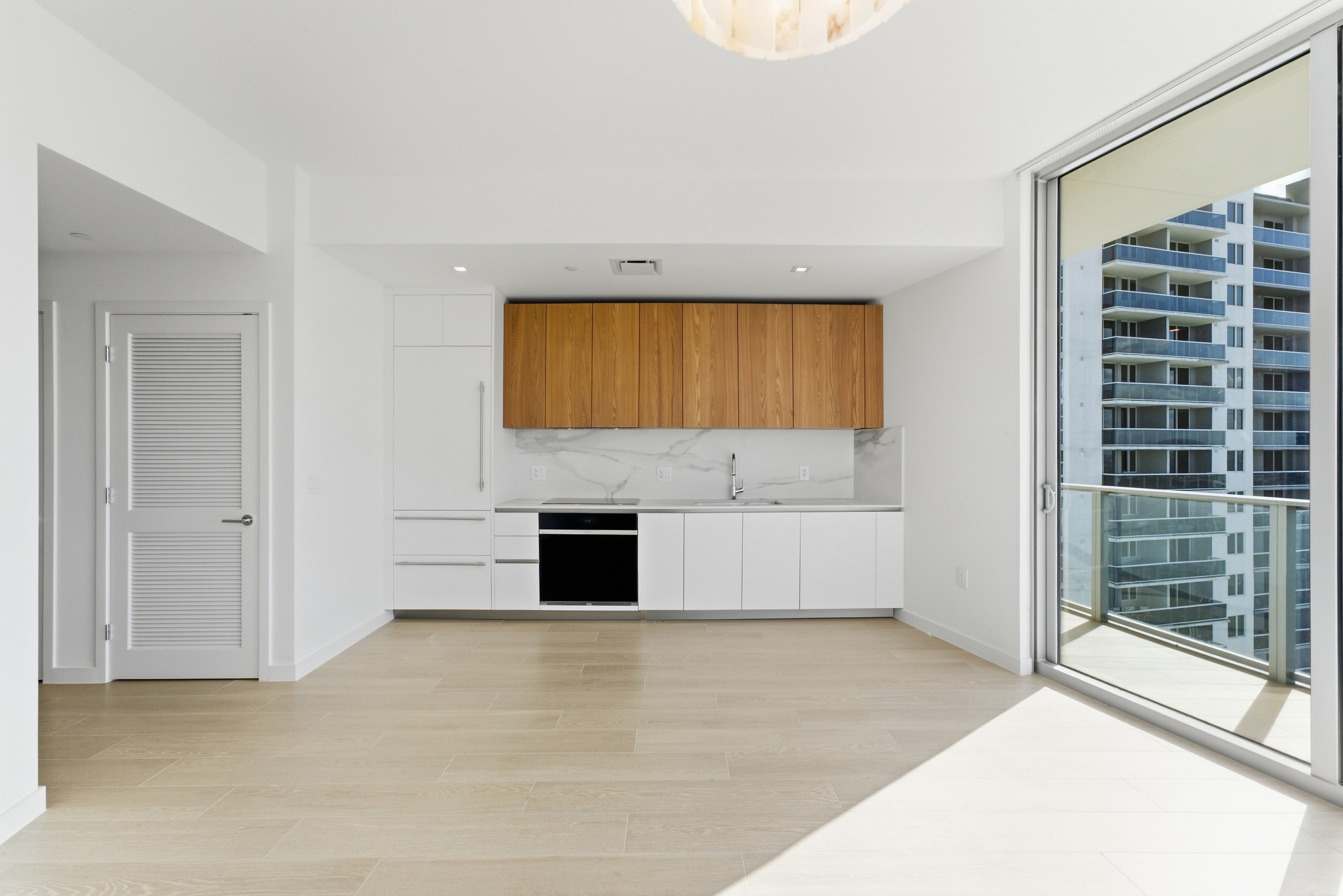 Open kitchen and living area with balcony beyond
