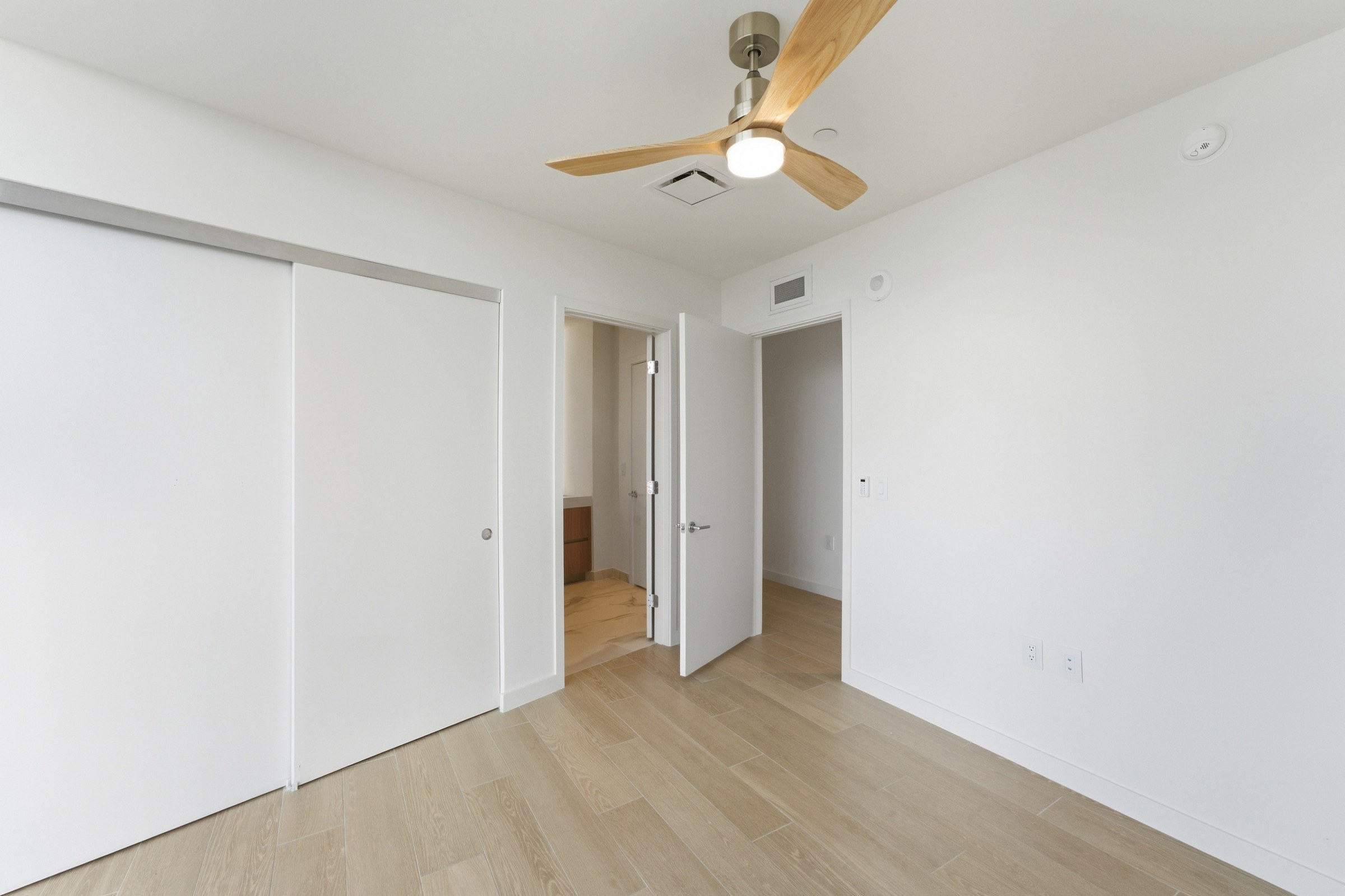 Bedroom interior with warm wood flooring