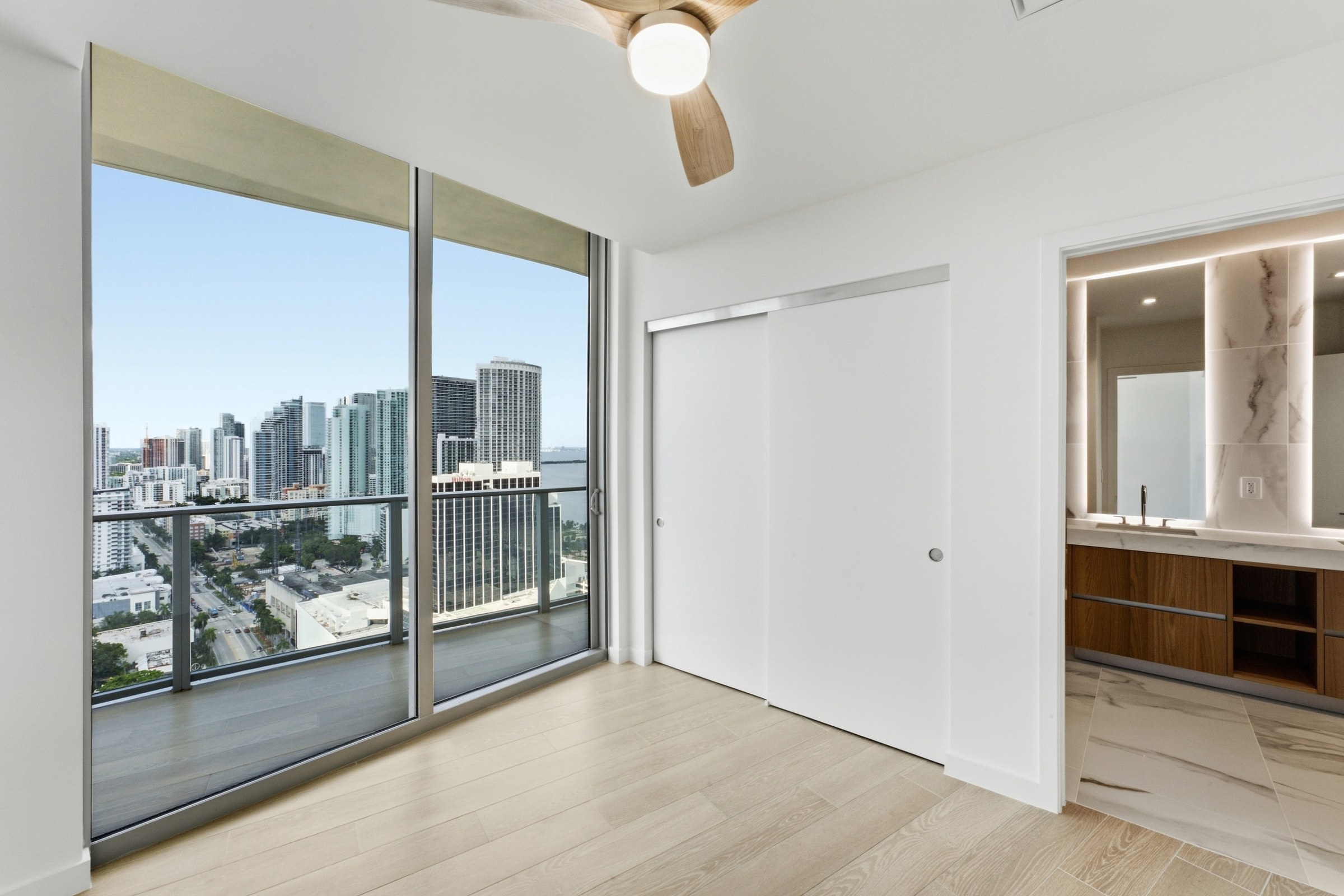Bedroom with balcony access and adjoining bathroom