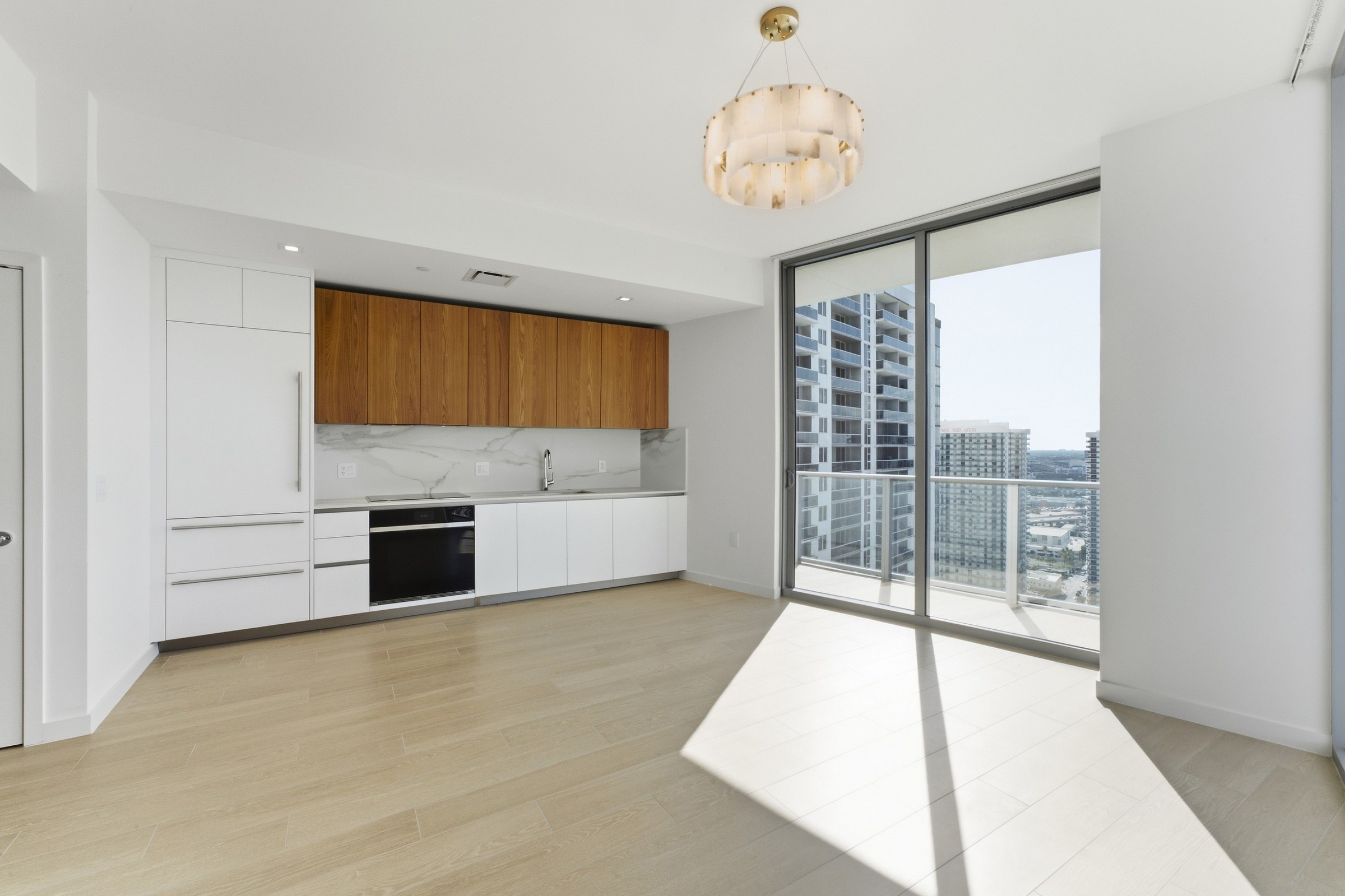 Streamlined kitchen with integrated appliances and wood cabinetry