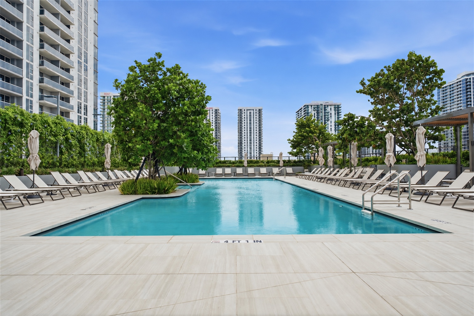 Landscaped lap pool and sun deck at Casa Bella Residences